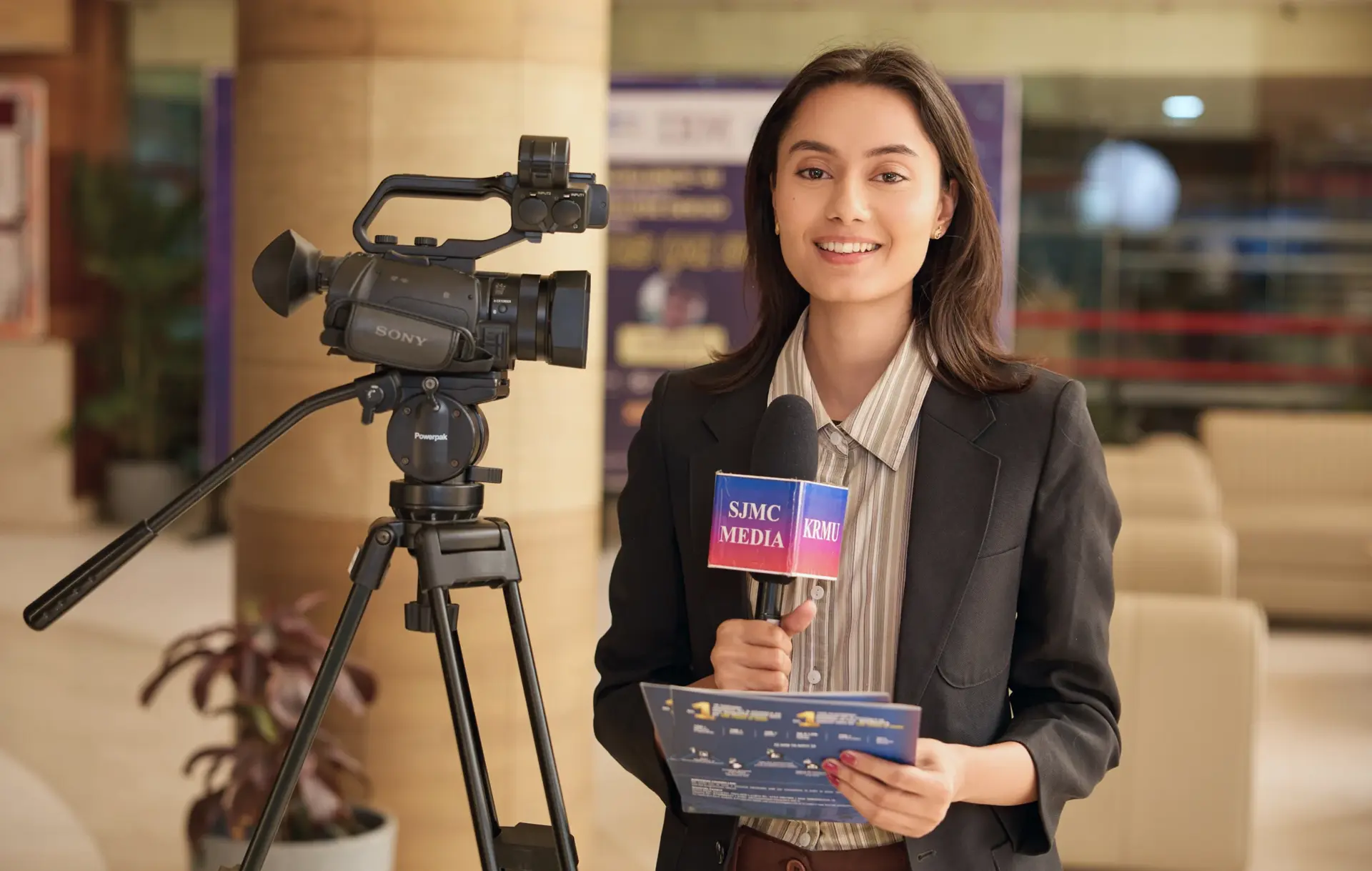 Journalism student reporting from the KRMU School of Journalism and Mass Communication studio