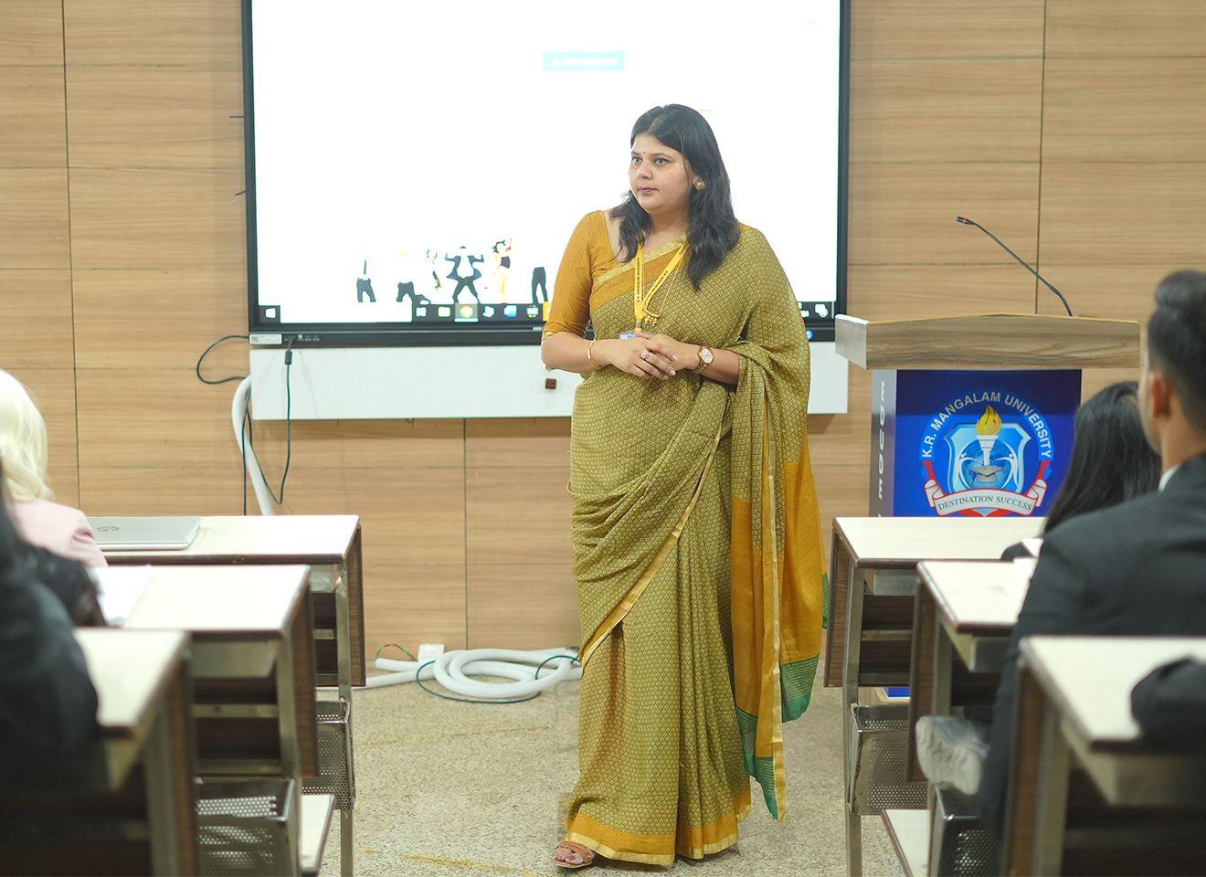 A guest academician or industry professional conducting a workshop or lecture for B.A. English students at KRMU