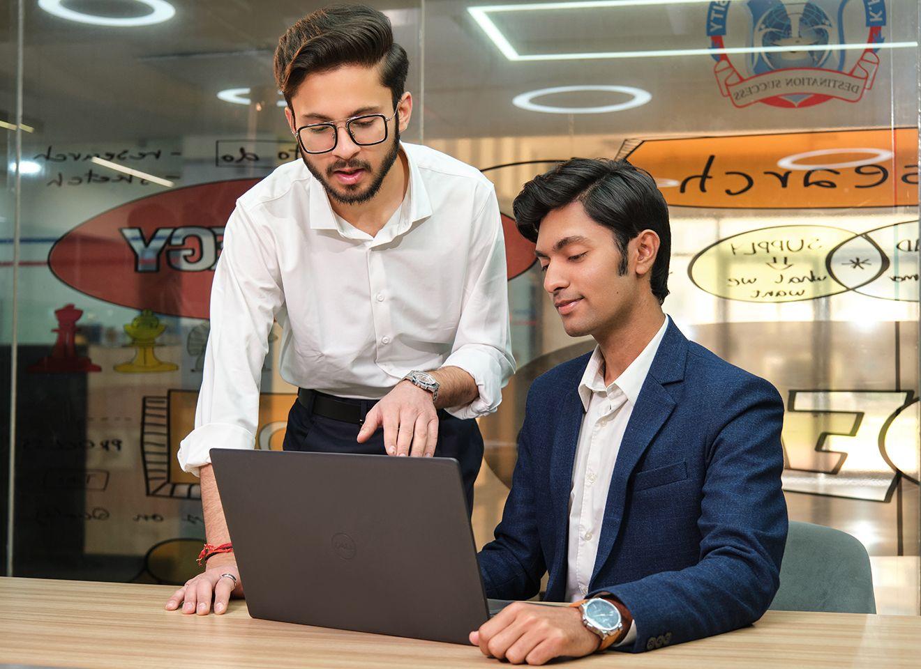 Faculty and students reviewing the B.A. Economics curriculum blending economic theory with financial systems, policy frameworks, and market analysis at KRMU