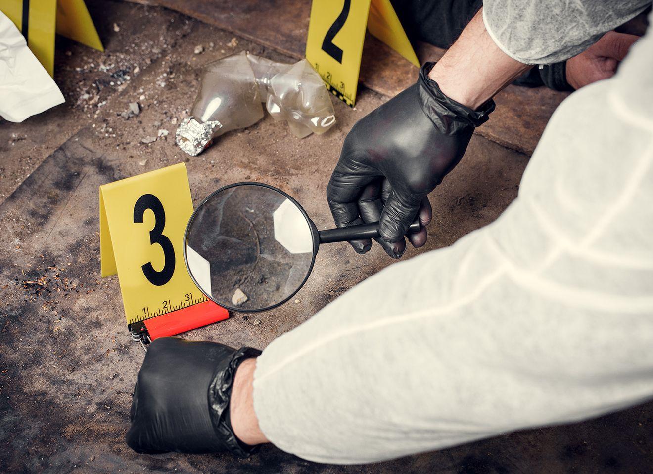 Students analysing a simulated crime scene set up in the forensic lab at KRMU for hands-on investigation training