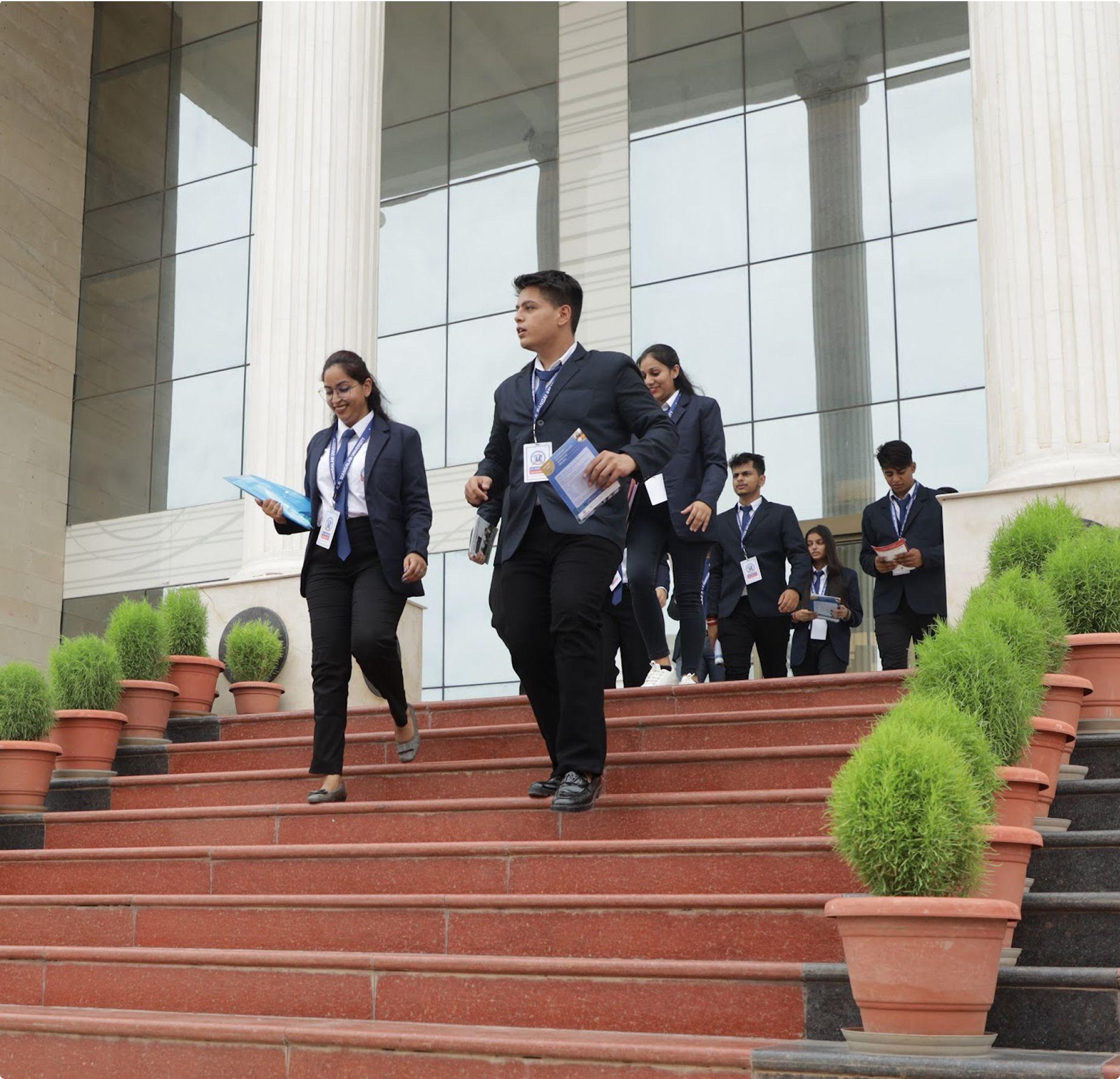 Cohort of MBA Fintech students walking on the KRMU campus steps