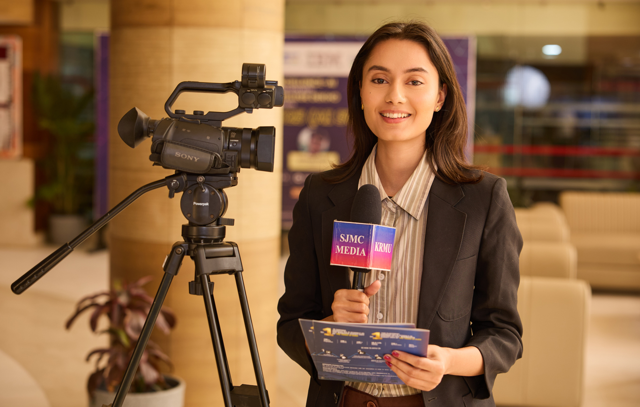 Journalism student reporting from the KRMU School of Journalism and Mass Communication studio